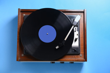 Obraz premium Record player with vinyl disc on color background