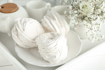 Plate with tasty white marshmallow on tray