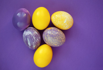 Painted Easter eggs on color background