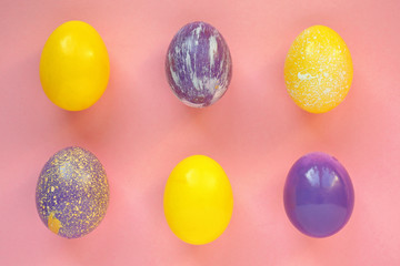 Painted Easter eggs on color background