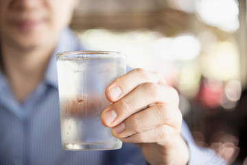 Man drink fresh cold pure water in glass