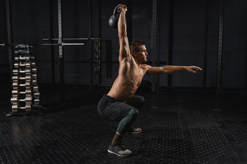 Kettlebells swing exercise man workout at gym. Crossfit training