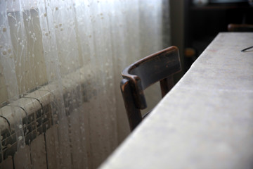 Old table and chairs in front of the window