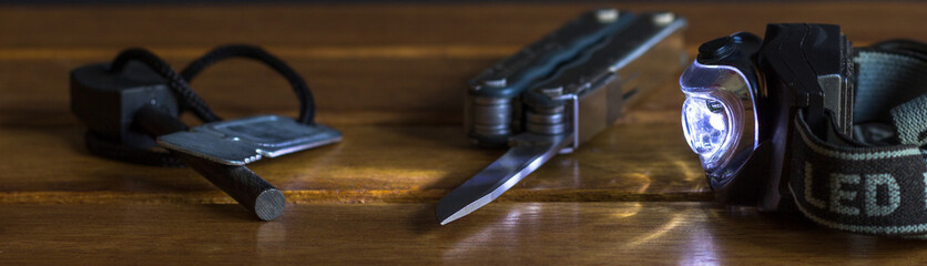 close up of pocket knife, flint and led head lamp