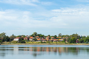 Fototapeta na wymiar Houses and their reflection on the water at Parramatta River. Sydney, Australia.