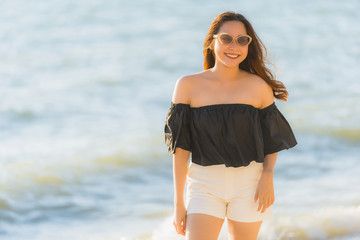 Portrait beautiful young asian woman happy and smile on the beach sea and ocean