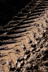 Heavy machinery tyre track impressions in mud on construction site 