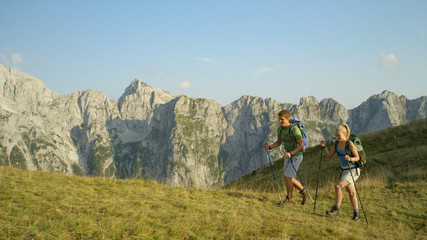 Fototapeta premium Happy tourist couple hiking in the breathtaking Slovenian mountains