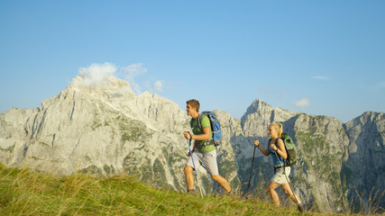 Cheerful trekker couple enjoying the sights as the hike through the Julian Alps.