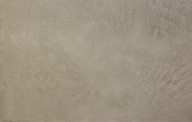 Photo of old gray cement wall with fractures.
