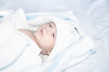 Adorable cute newborn baby boy on white background. The lovely child wore a rabbit costume with long ears. Holiday, Easter.