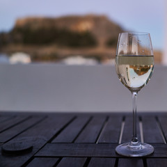 The reflection of the acropolis of Lindos in a glass of white wine. Rhodes Island Greece