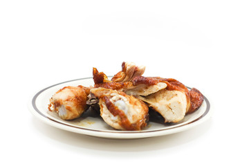 Grilled chicken on ceramic dish and white background