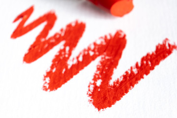 Smudged lipstick on white background