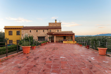 Fototapeta premium Luxury private villa terrace with red tile and with a beautiful view of the garden.