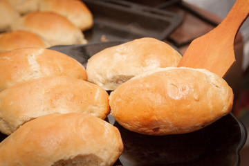 Delicious ruddy freshly baked pies laid out on a black plate