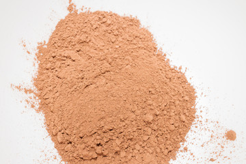 Dry cocoa powder poured in a mixing bowl