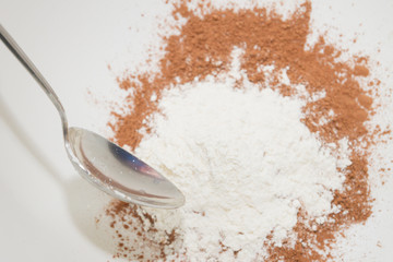 The flour is mixed with dry cocoa powder in a mixing bowl