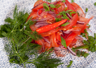  juicy, summer vegetable salad cutting from fresh vegetables and greens in a beautiful serving on a wooden table for decoration and design