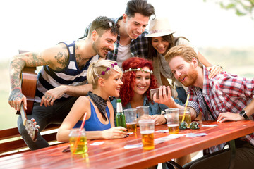 Youth group on excursion looking photos on mobile phone