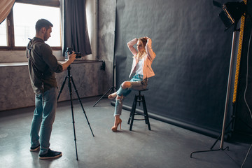 confident hipster showing her cool clothes and hairstyle to the camera. side view photo