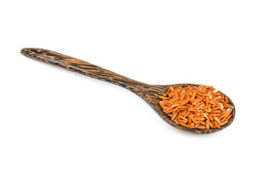 brown rice in wood spoon isolated on white background