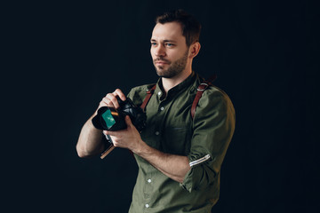 pensive handsome man preparing for photo session, close up photo. isolated black background