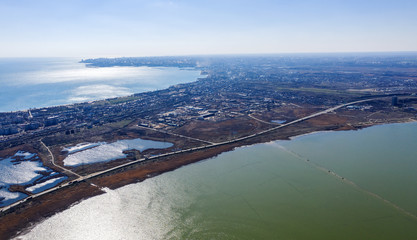 Top view of the coastal zone of the ecological reserve Kuyalnik estuary, Odessa, Ukraine. Aerial view from drone to sea estuaries in a suburban area near urban buildings