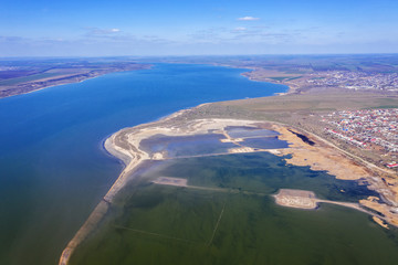 Top view of the coastal zone of the ecological reserve Kuyalnik estuary, Odessa, Ukraine. Aerial view from drone to sea estuaries in a suburban area near urban buildings