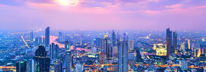 View commercial modern building and Chao Phraya river in city downtown at evening time, Bangkok Thailand 
