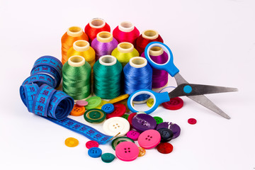 Colored thread coils on white background, sewing, place for text