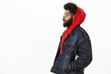 Profile shot of dreamy and thoughtful handsome stylish african american guy in denim jacket over...