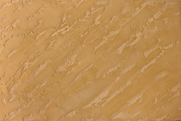 Photo of old gold cement wall with fractures. Texture for pattern.