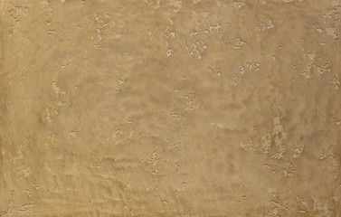 Photo of old gold cement wall with fractures. Texture for pattern.