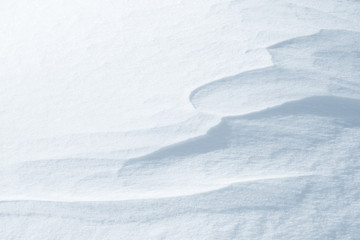 Fresh snow background texture. Winter background with snowflakes and snow mounds. Snow lumps.