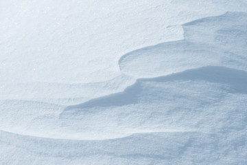 Fresh snow background texture. Winter background with snowflakes and snow mounds. Snow lumps.