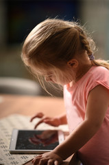 child playing with a tablet