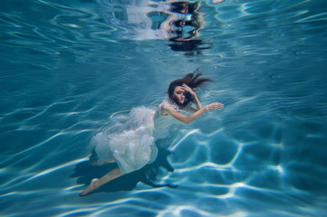 young woman underwater in different poses