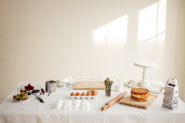 Preparation for making the dough. necessary ingredients for the cake: flour, eggs, rolling pin, whisk, milk. side view