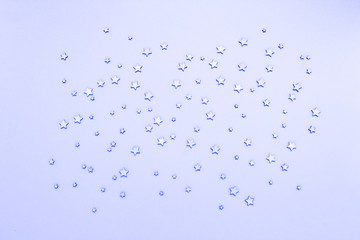 Decorative stars on a blue background. Concept of the night sky. Can be used as wallpaper or background. Flat lay, top view