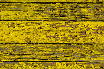 Old wooden boards with cracked yellow paint