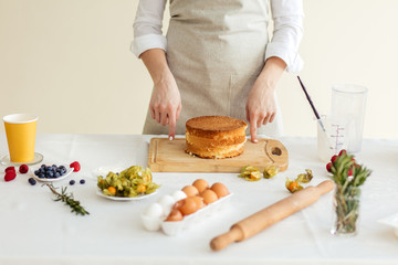 Woman prepared pancakes for cake, close up photo. rolling pin, berries, eggs.close up cropped photo
