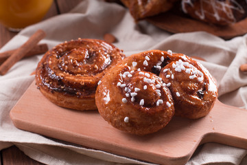 Fresh pastries for Breakfast on a wooden Board. Wooden background