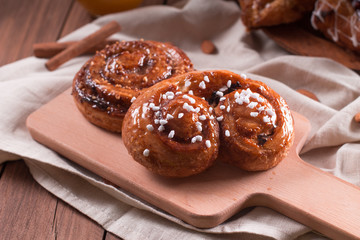 Fresh pastries for Breakfast on a wooden Board. Wooden background
