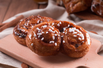 Fresh pastries for Breakfast on a wooden Board. Wooden background