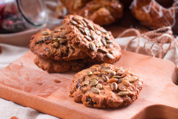 Oatmeal vegetarian cookies with pumpkin seeds. Wooden background