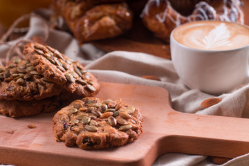 Oatmeal vegetarian cookies with pumpkin seeds. Wooden background