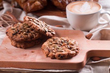 Oatmeal vegetarian cookies with pumpkin seeds. Wooden background