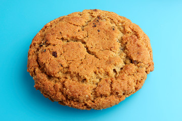 Chocolate chip cookie isolated on blue bakcground, top view. Conceptual view.