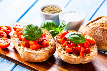 Bruschettas on cutting board on wooden background